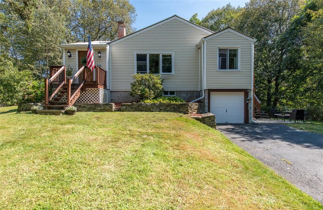 a view of a house with backyard and sitting area