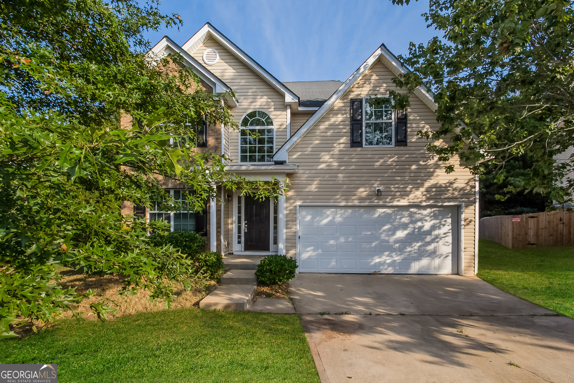 a front view of a house with a yard