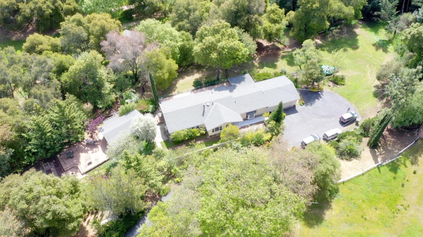 an aerial view of residential house with swimming pool and lawn chairs