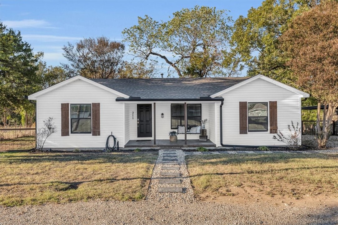 a front view of house with yard outdoor seating and barbeque oven