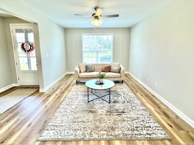 a living room with a couch dining table and a rug