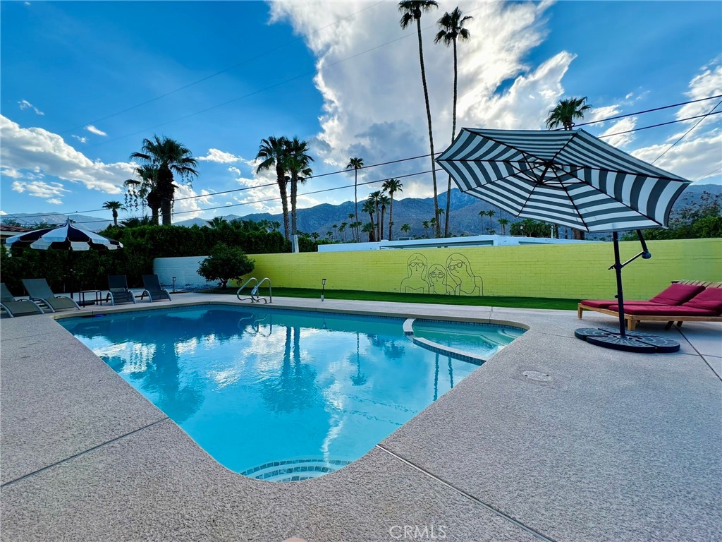 a view of a swimming pool with a yard