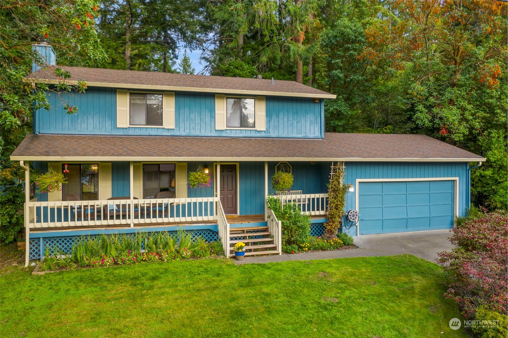 a front view of a house with a garden