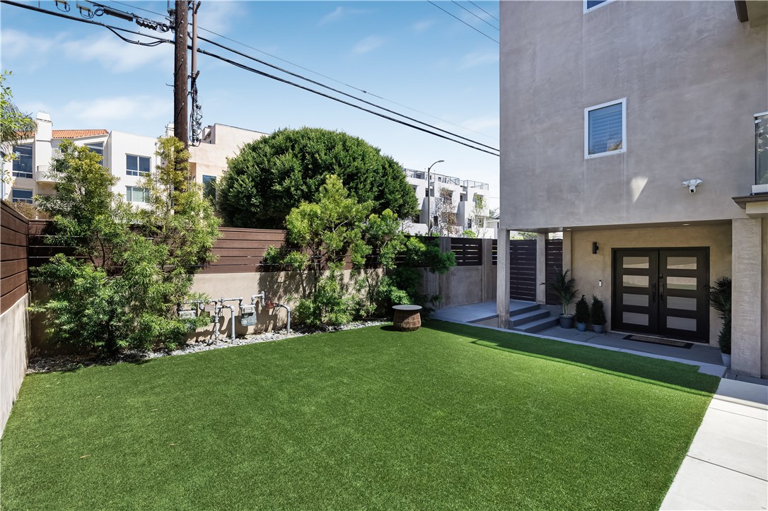 a view of a house with a yard and sitting area