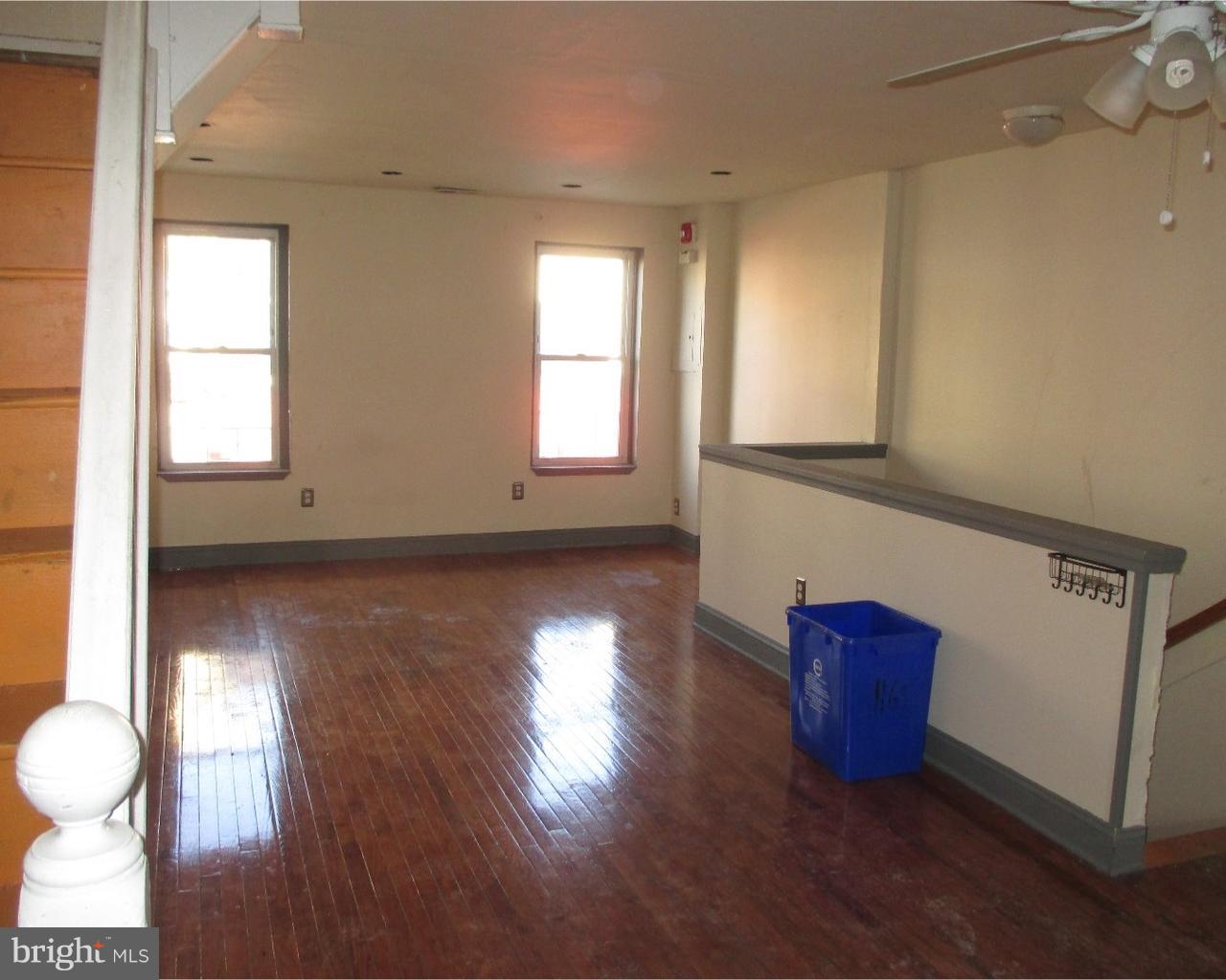 a view of room with wooden floor and window