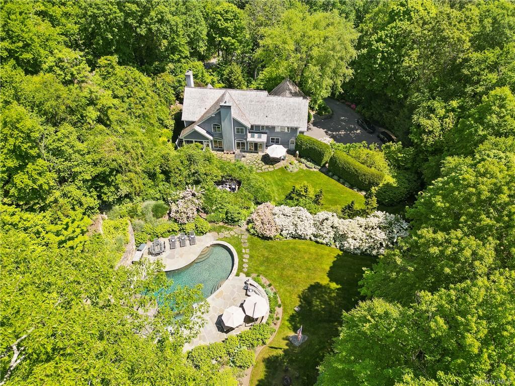 an aerial view of a house with a yard basket ball court and outdoor seating