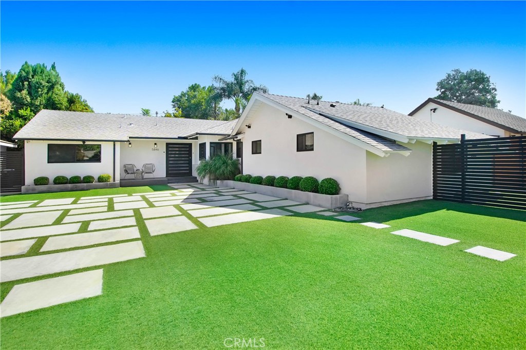 a view of a house with a yard porch and sitting area