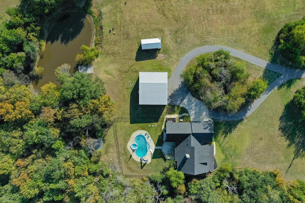 an aerial view of a house with swimming pool and garden