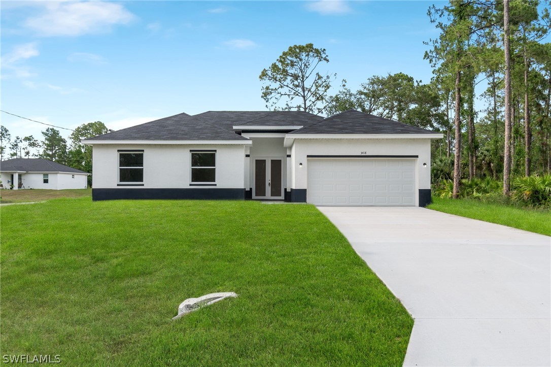 a front view of house with yard and green space