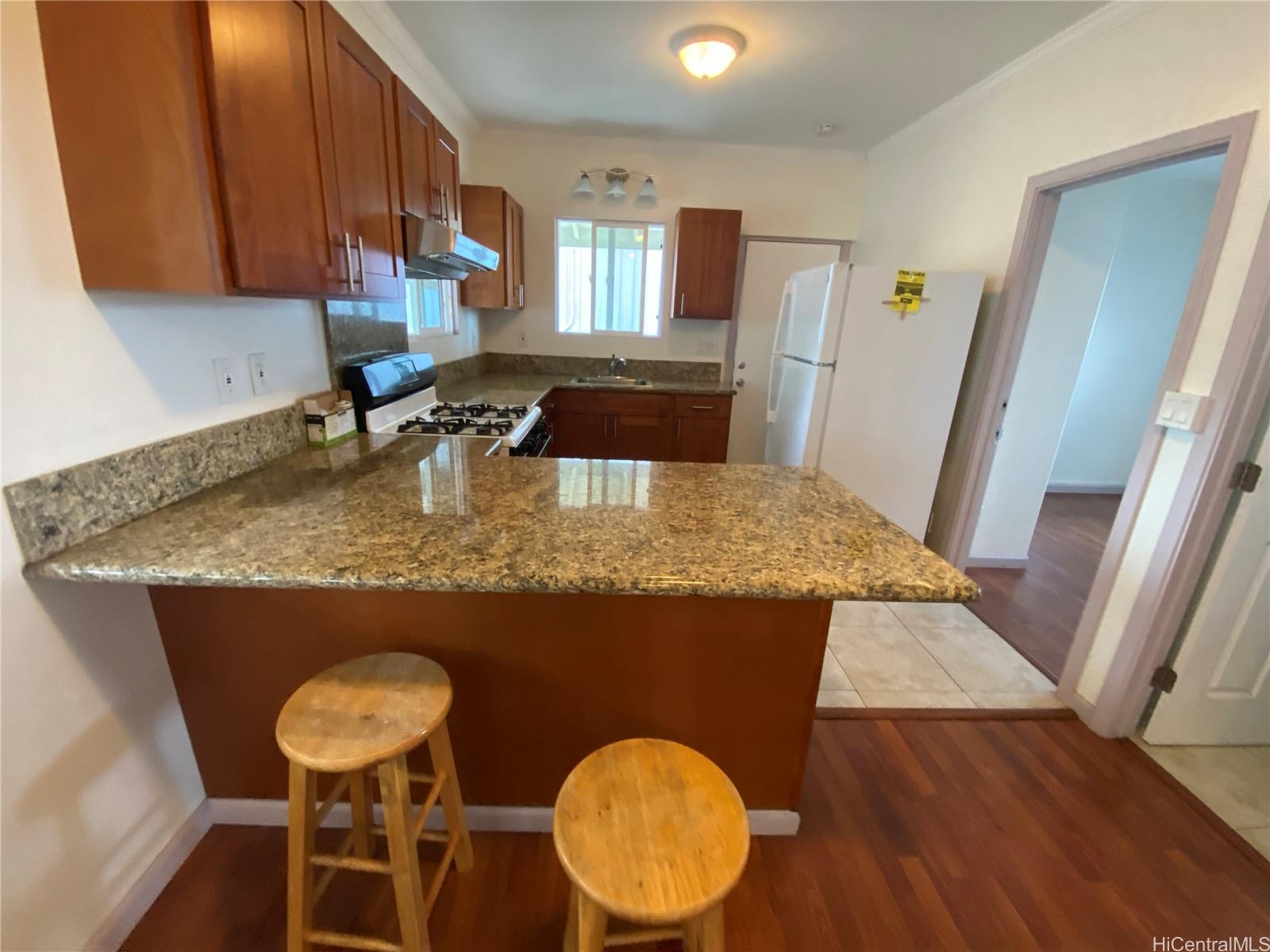 a kitchen with a sink a table and chairs