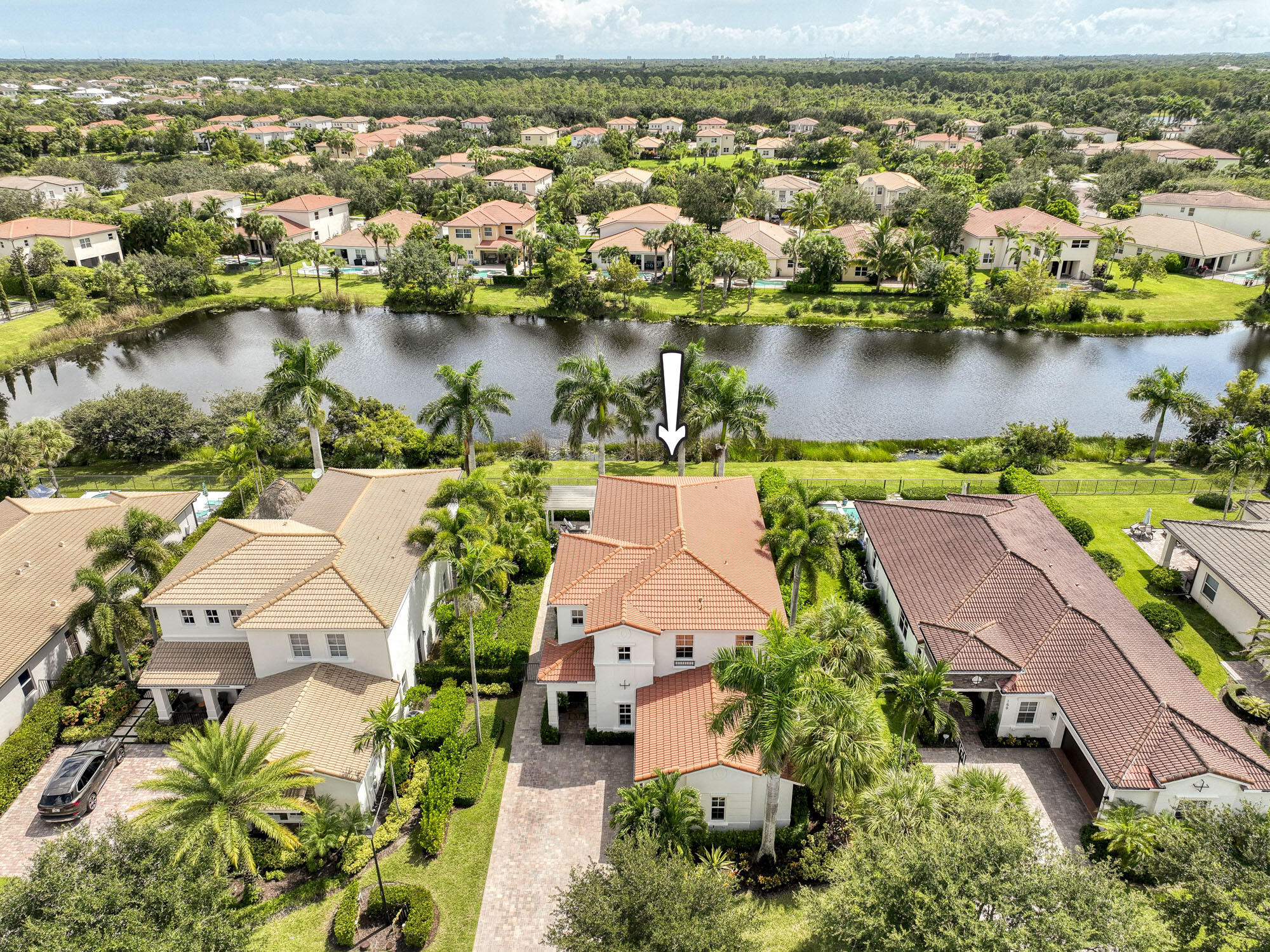 an aerial view of residential houses with outdoor space and lake view