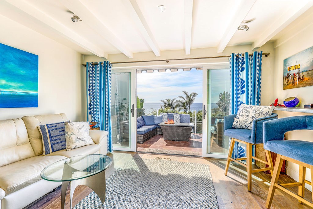 a living room with furniture and a floor to ceiling window