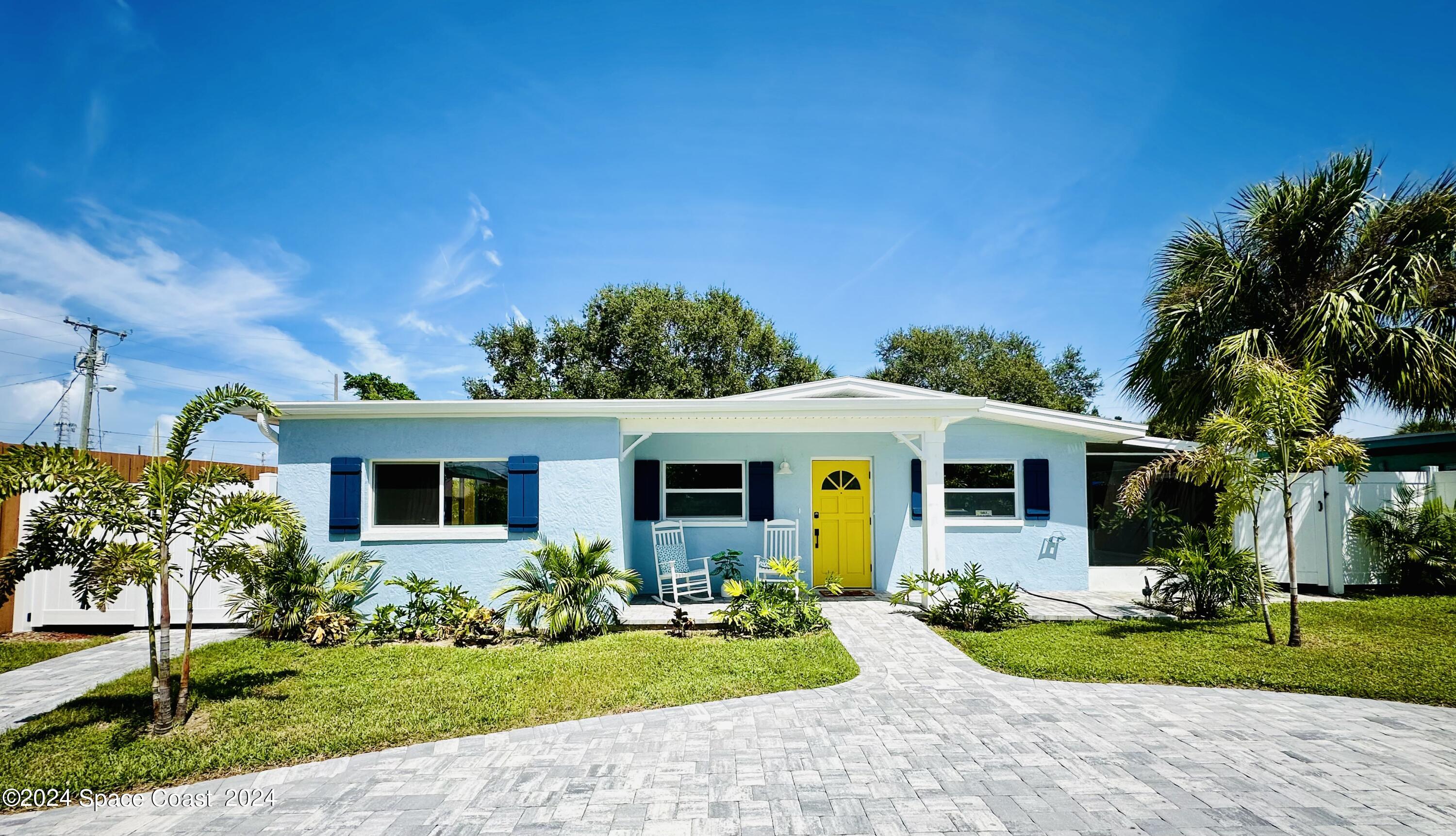 a front view of house with yard and green space