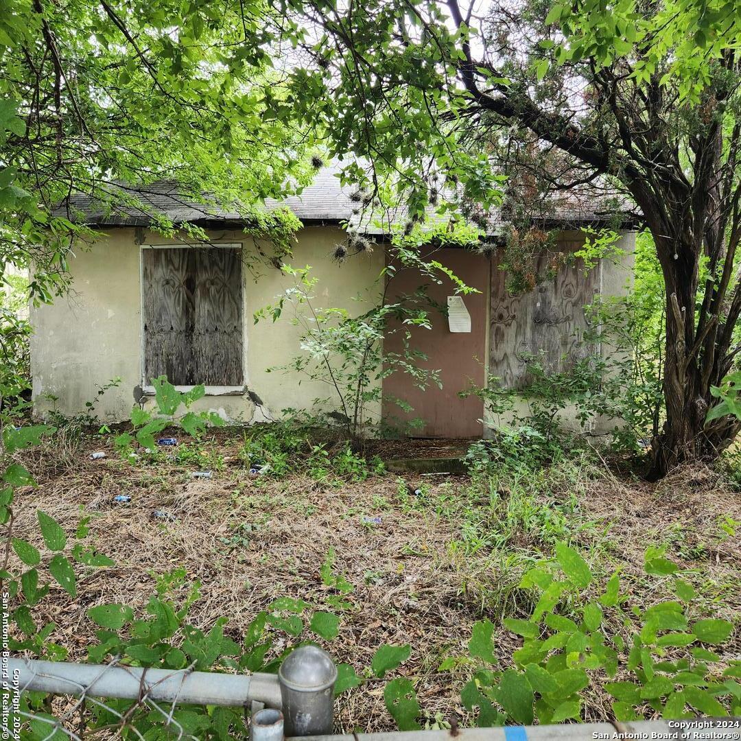 a small house with a trees in the background