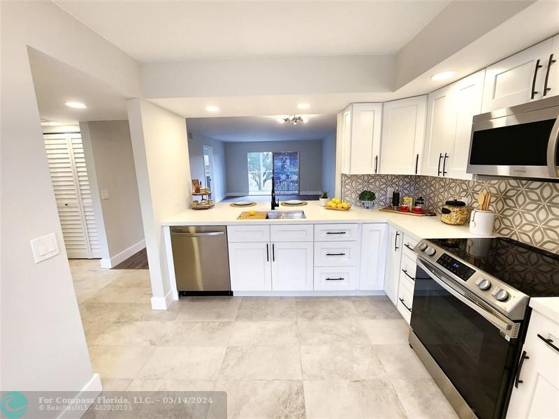 a kitchen with a stove a sink and a microwave