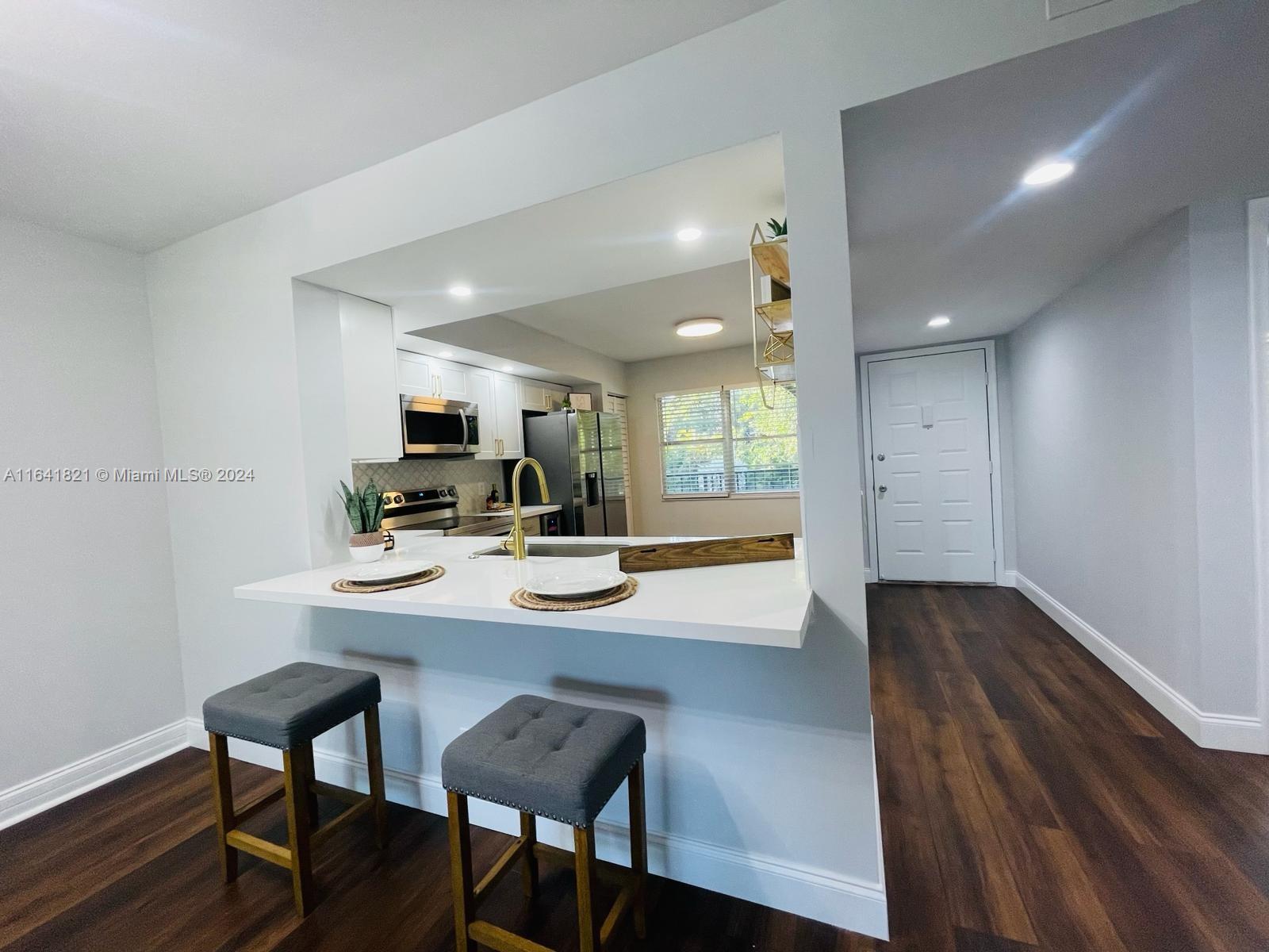 a view of a dining room with furniture and a wooden floor