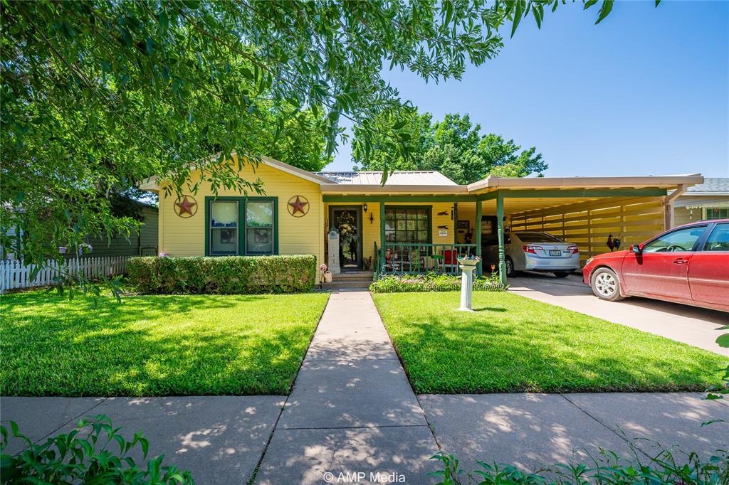 a front view of house with yard and green space