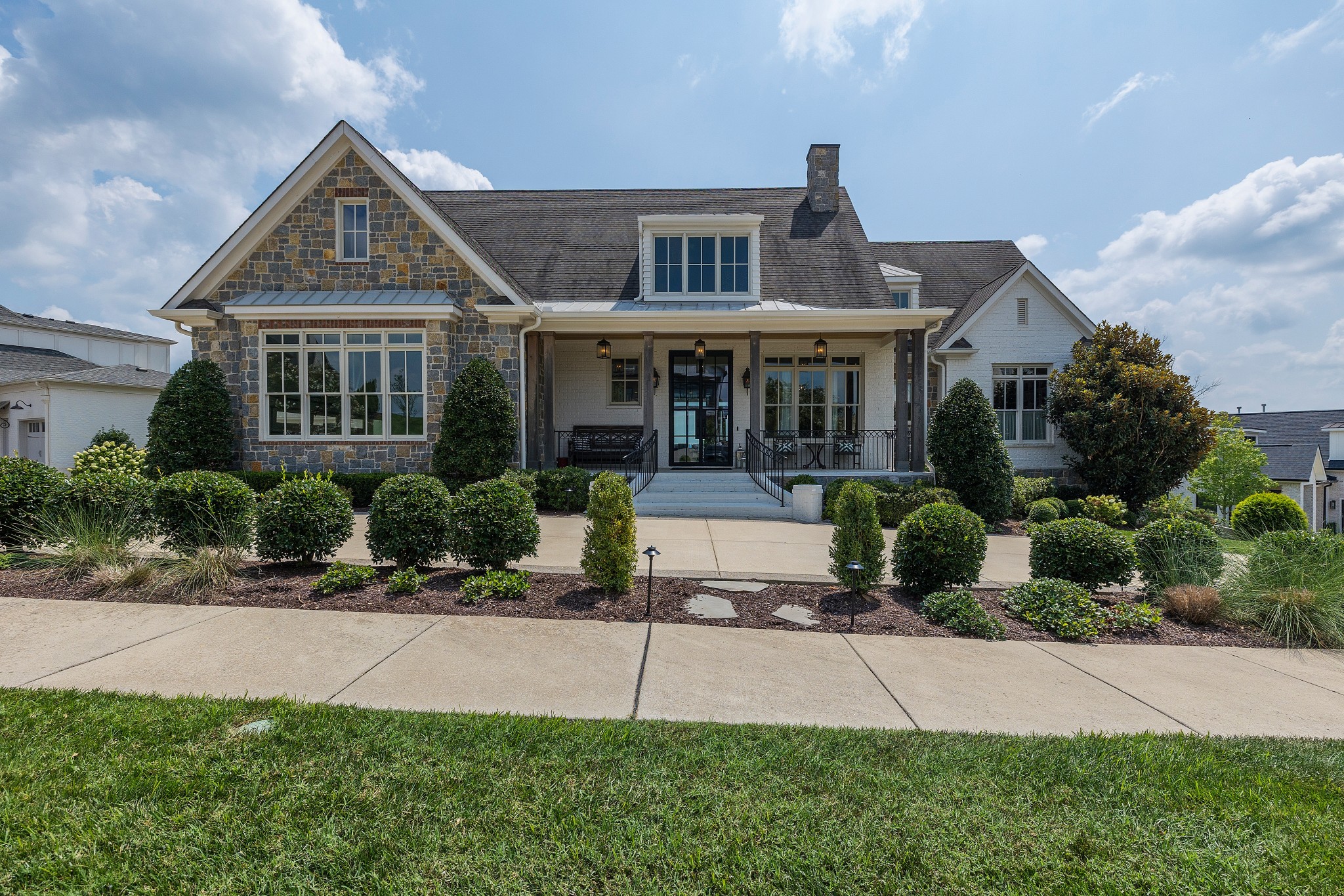 a front view of a house with a garden