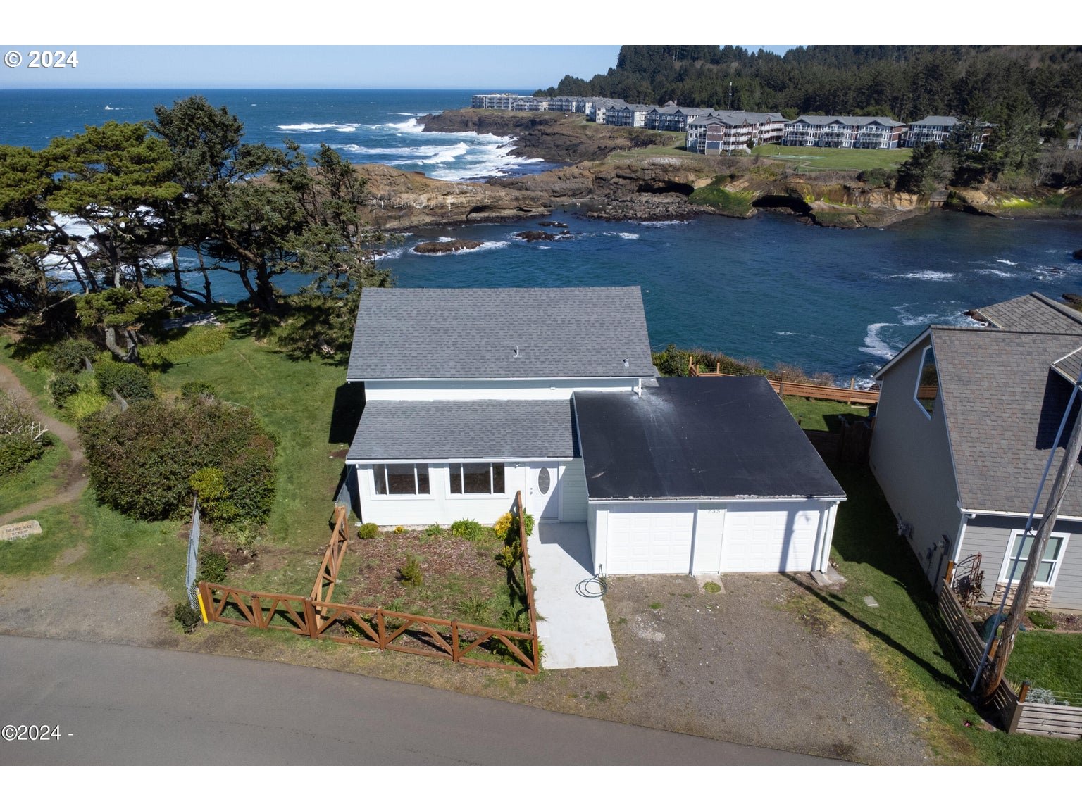 an aerial view of a house with a yard basket ball court and outdoor seating