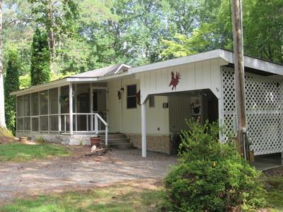 a view of a house with a yard and porch