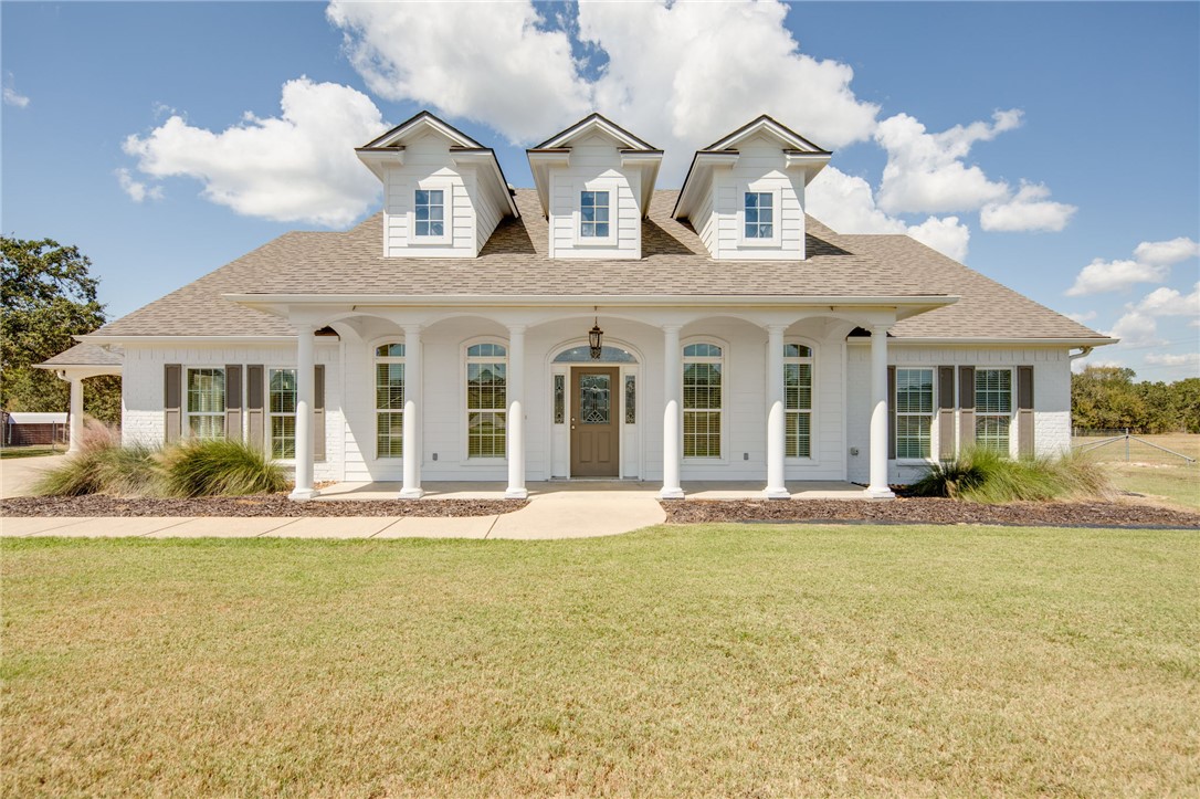 front view of a house with a swimming pool