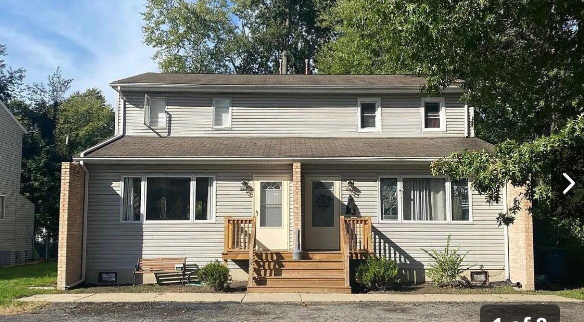 a side view of a house with a porch