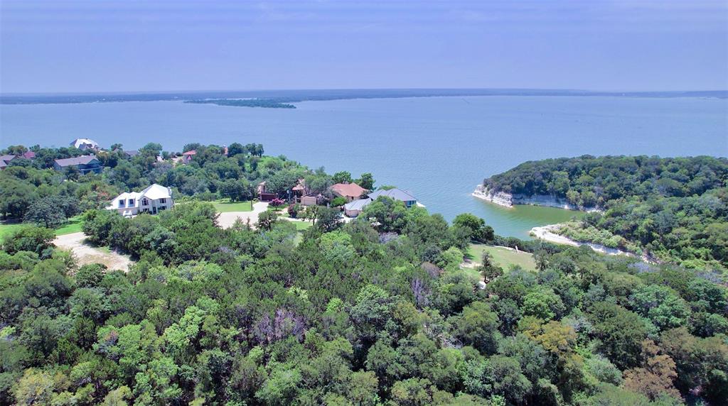 a view of a lake in middle of green field