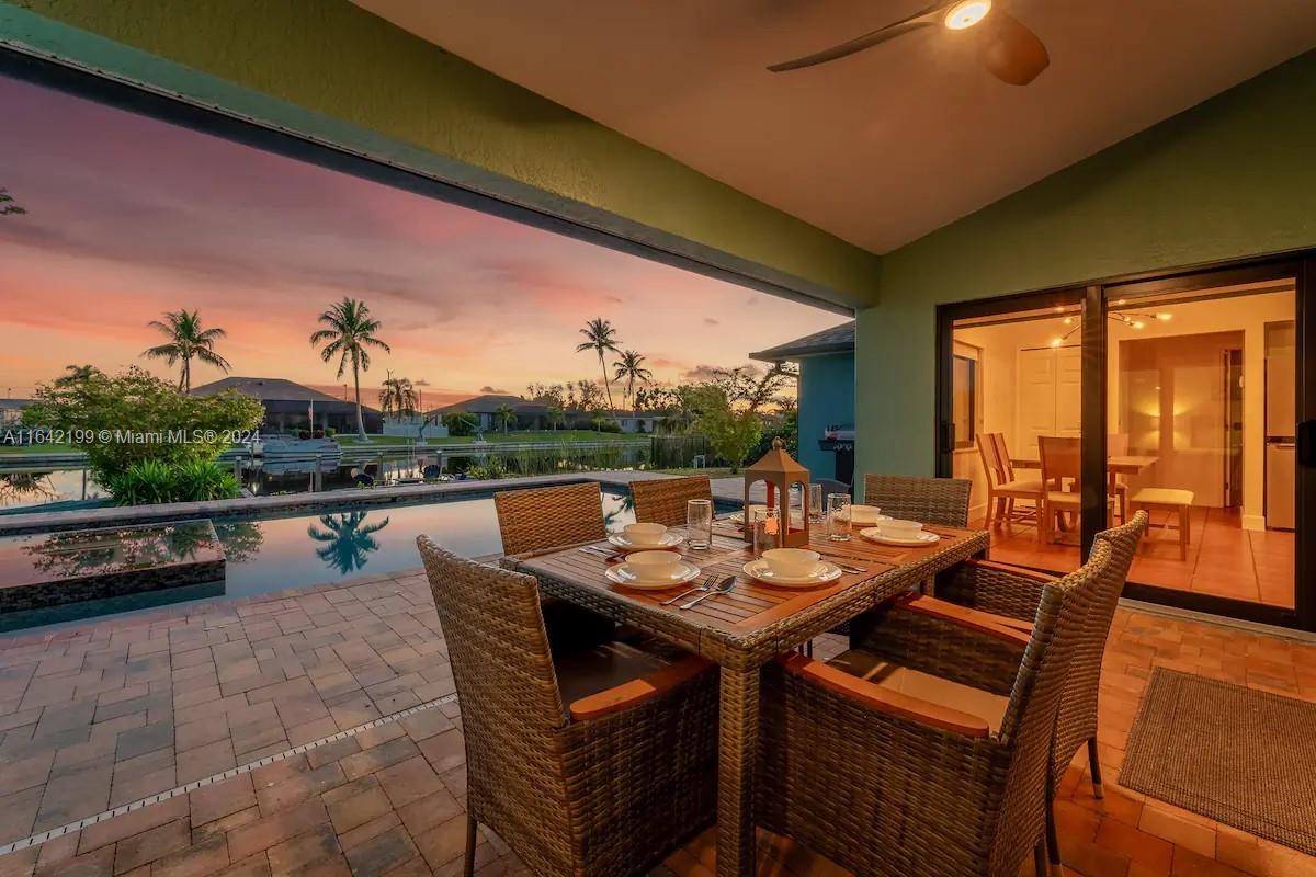 a view of a patio with a dining table and chairs