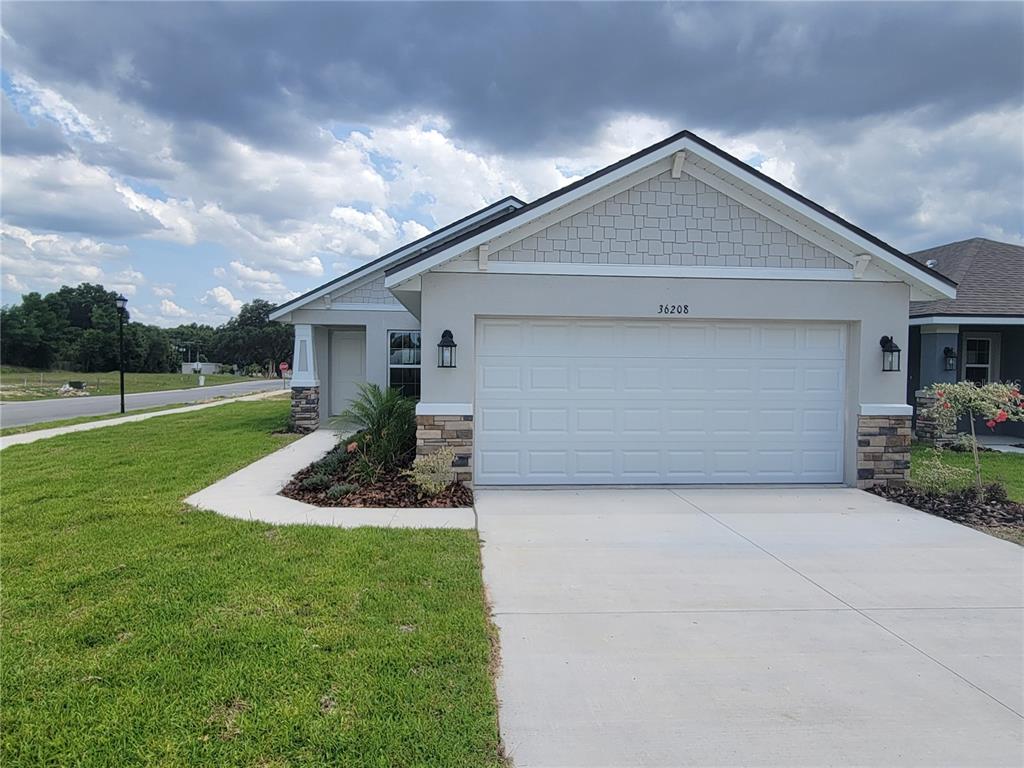 a front view of house with yard and green space