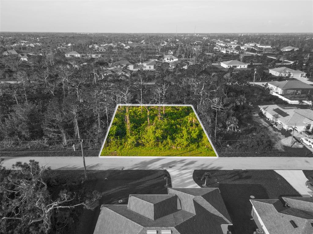 an aerial view of residential houses with yard