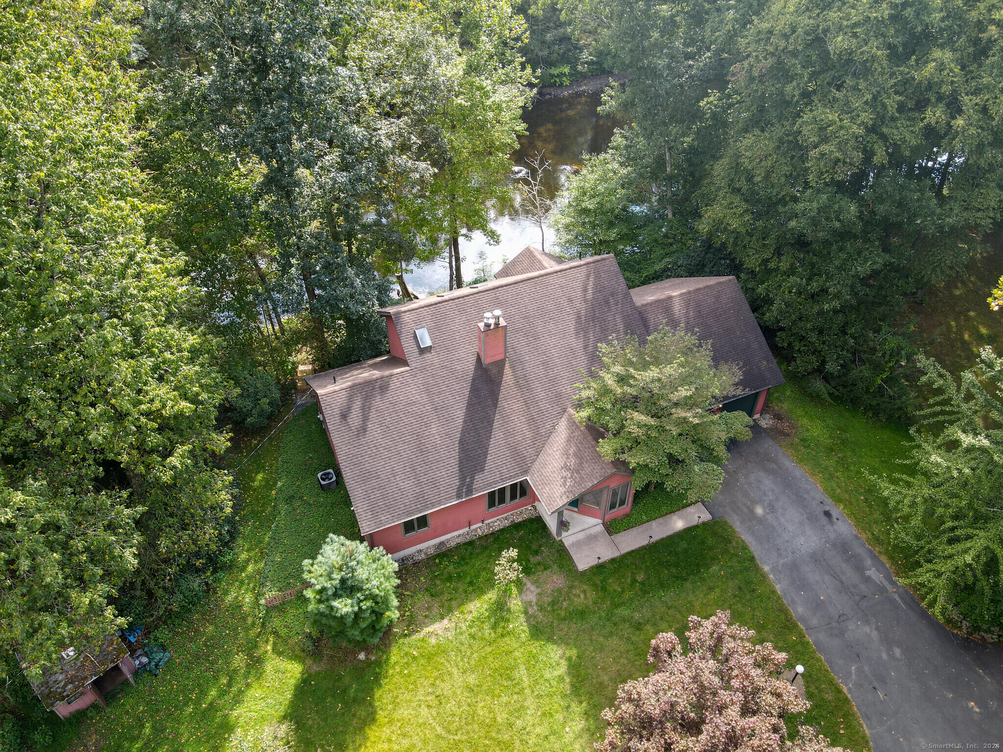 an aerial view of a house with a yard basket ball court and outdoor seating