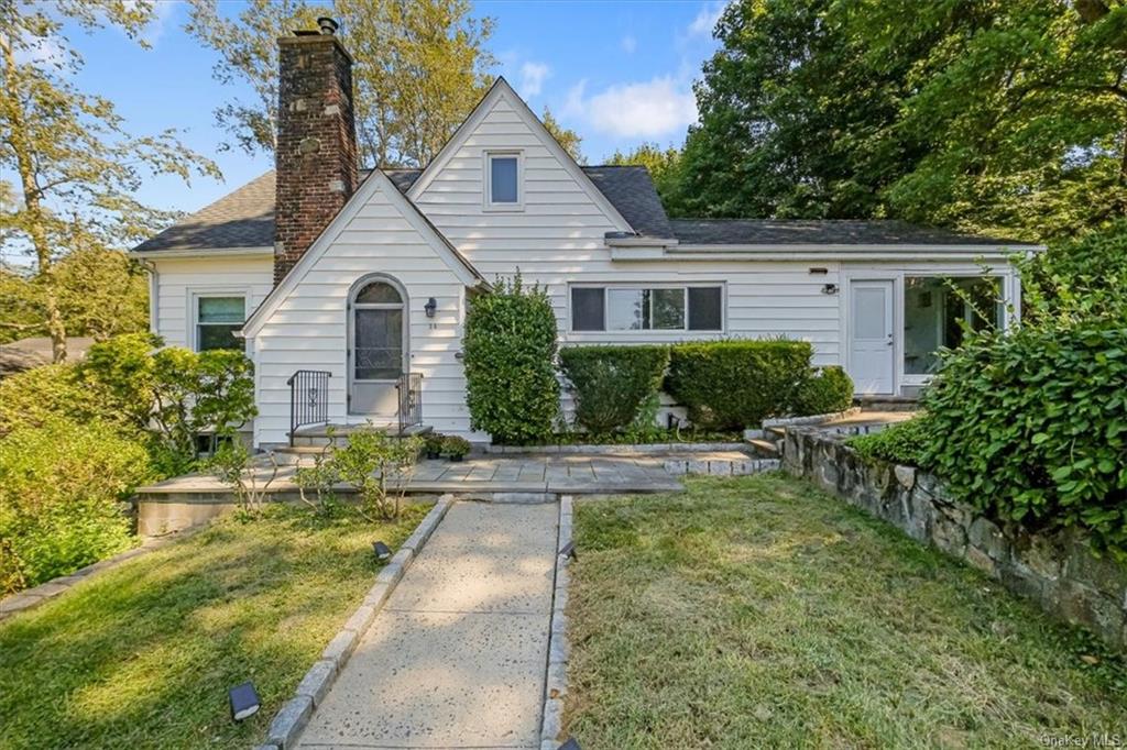 a front view of house with yard and green space