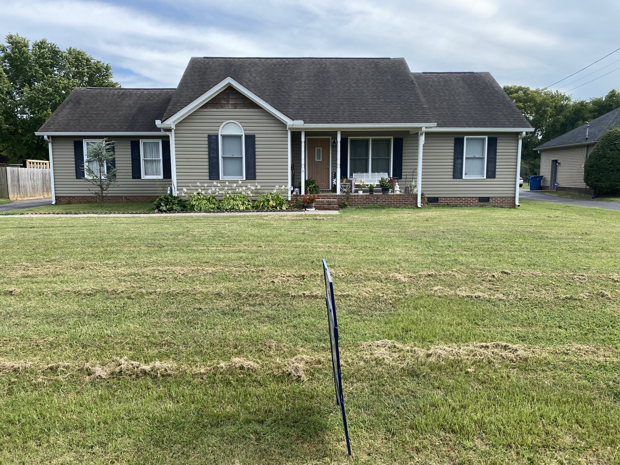 a front view of a house with a garden and porch