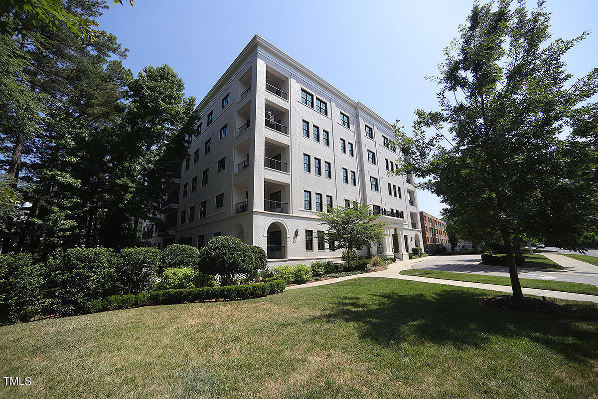 a view of a building with a yard