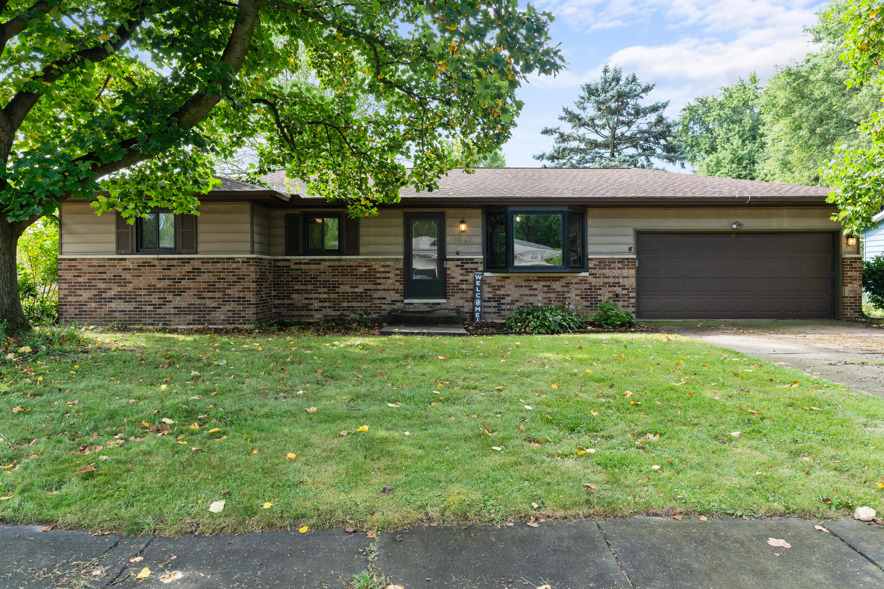 a front view of house with yard and trees