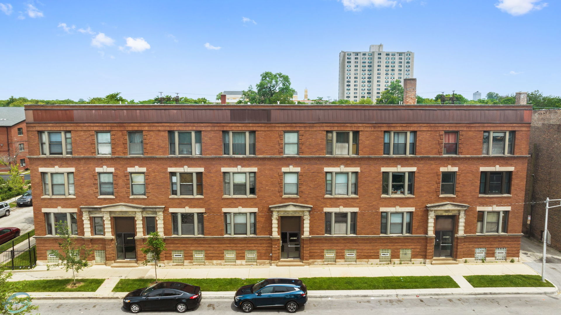 a front view of a residential apartment building with a yard