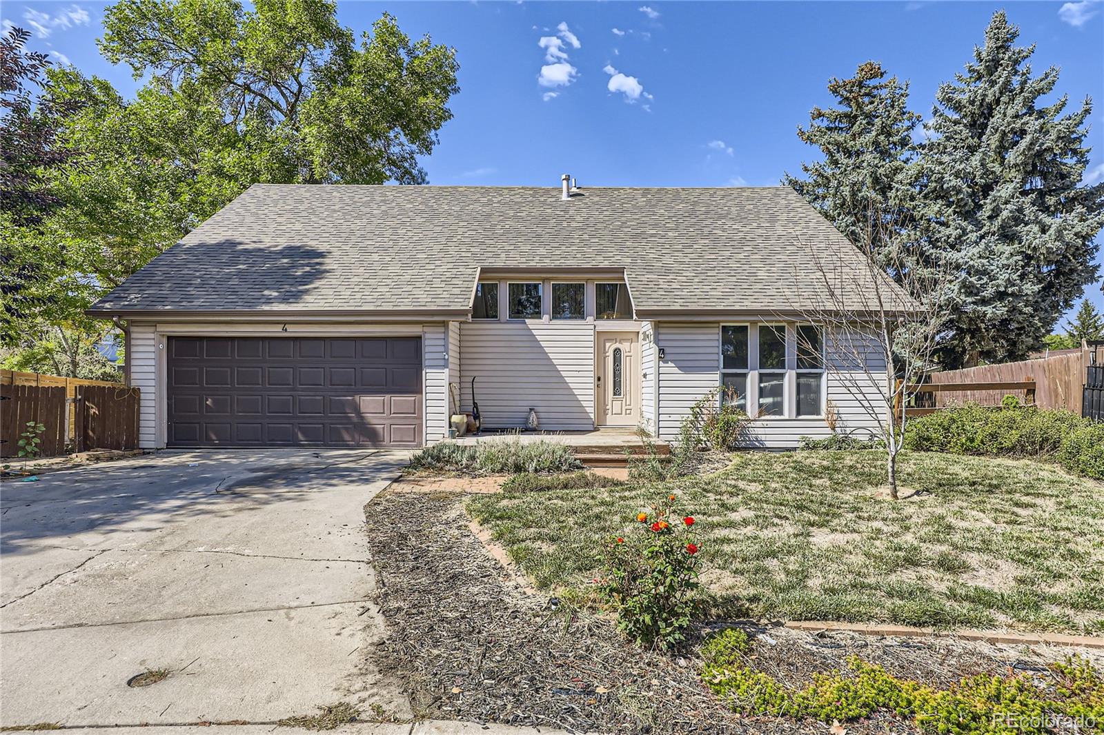 a front view of a house with a garden and yard