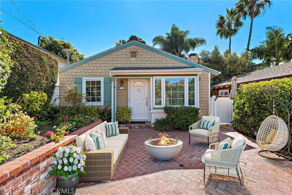 a view of a house with backyard sitting area and garden