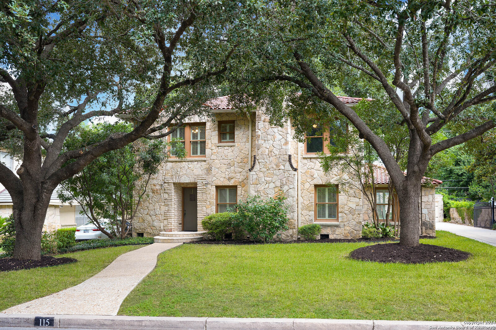 a front view of a house with garden