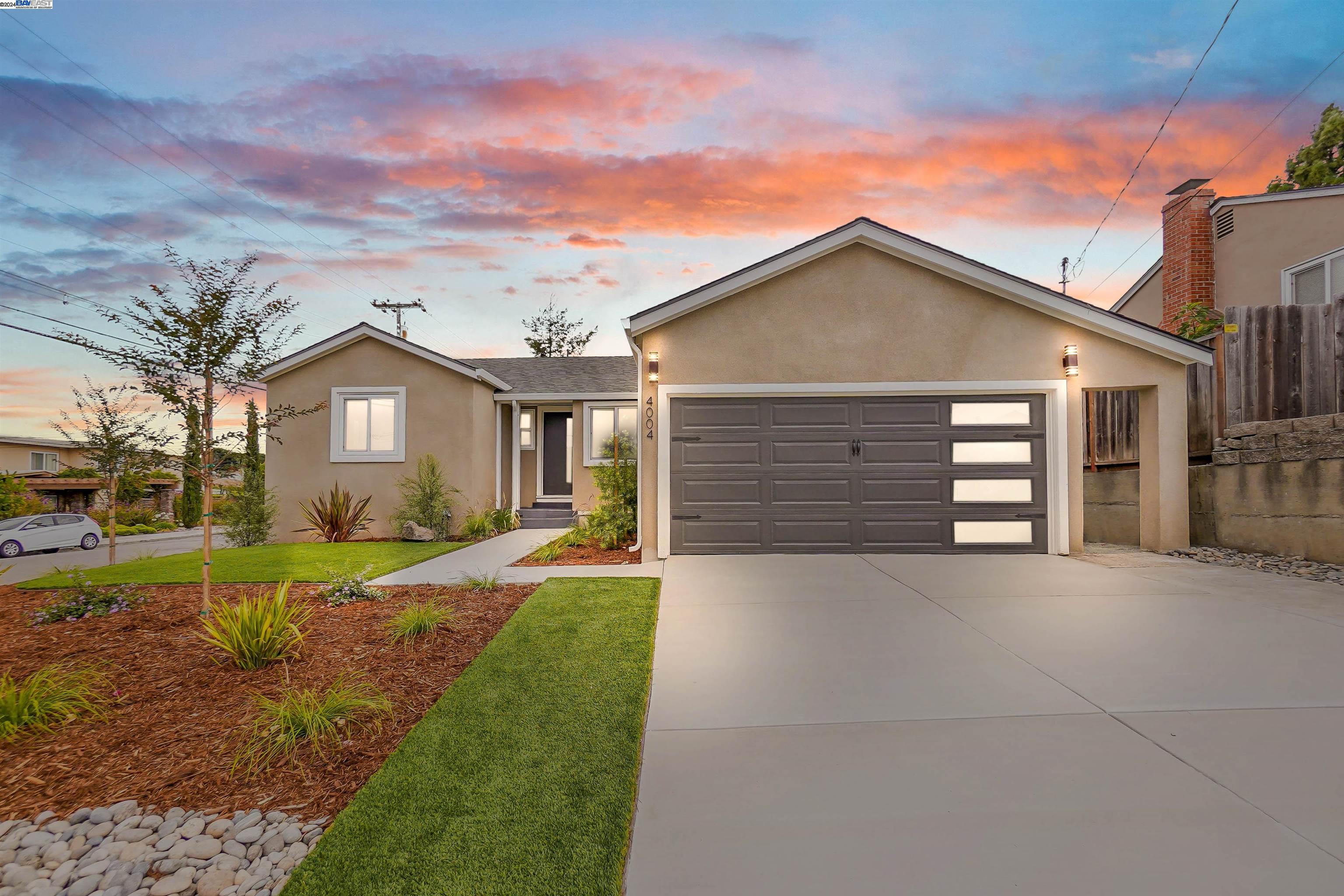 a front view of a house with a yard and garage