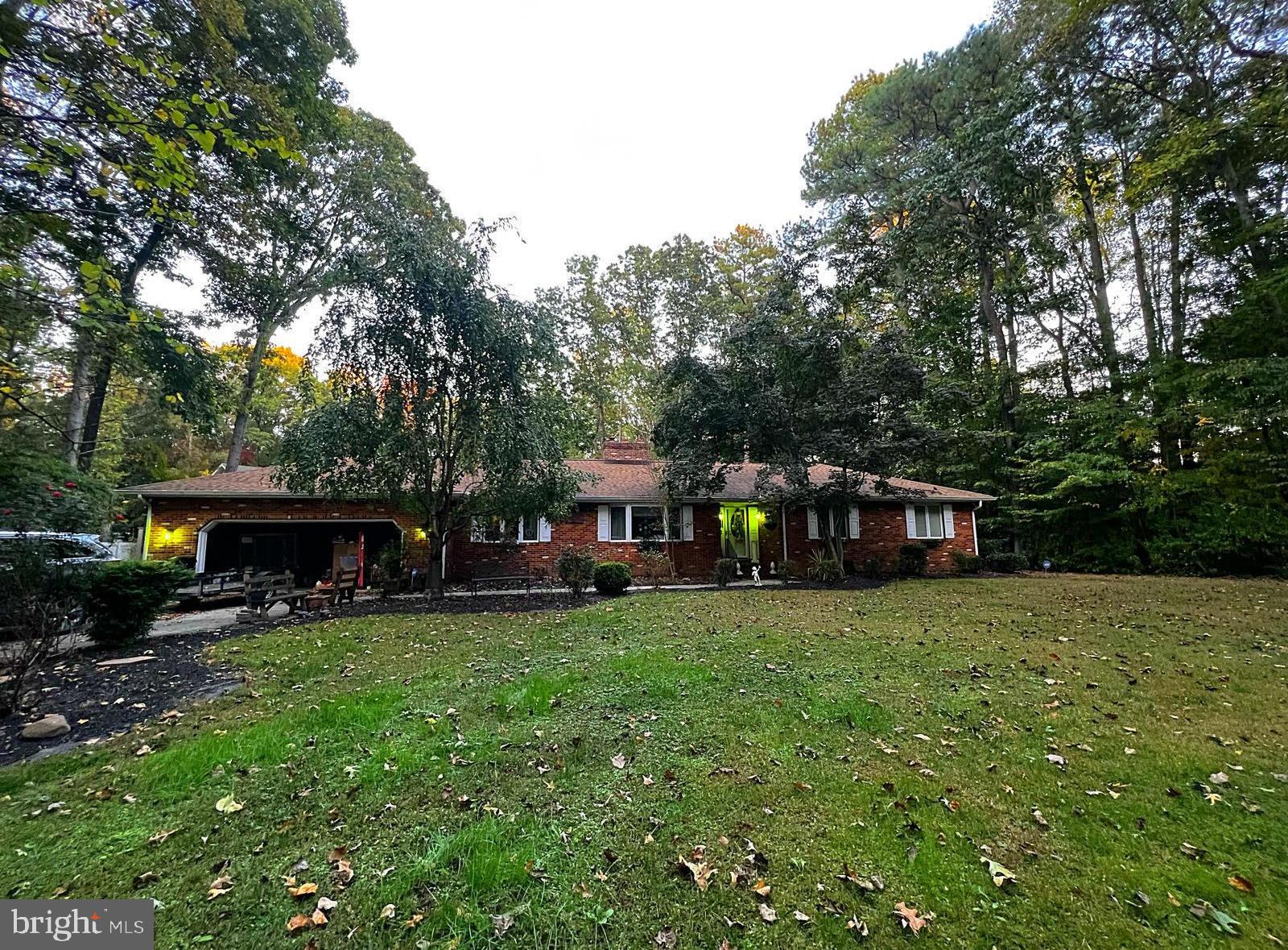 a view of a house with a yard and sitting area