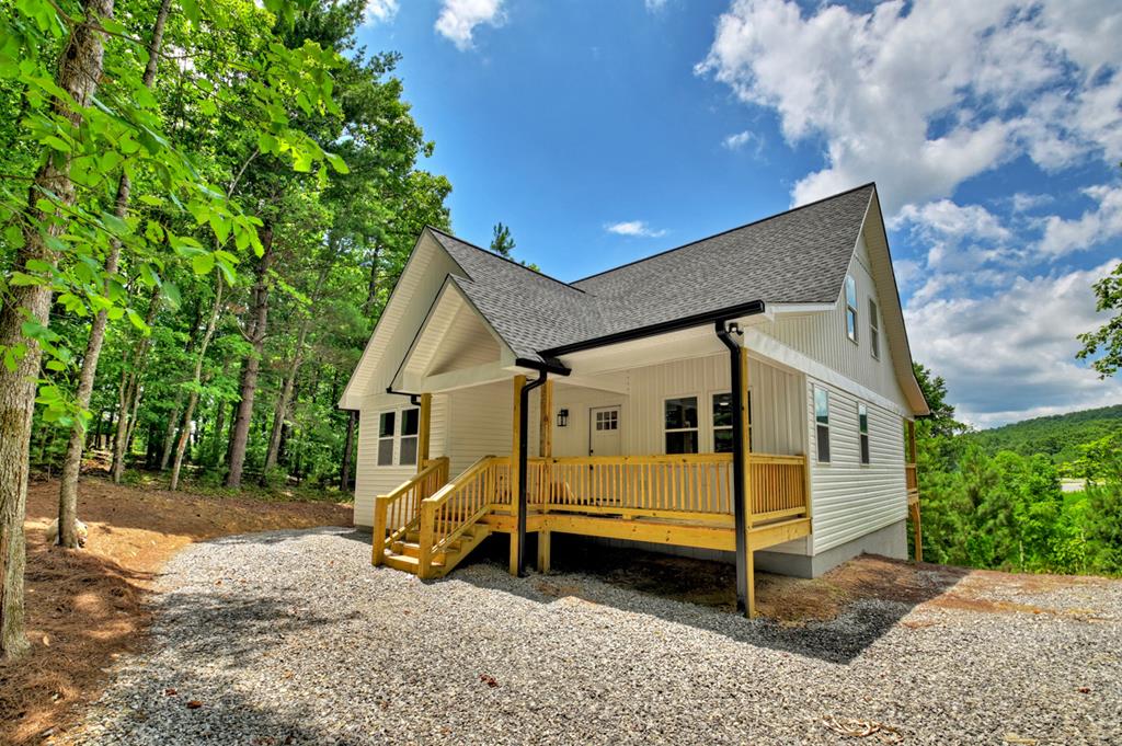 a view of a house with a backyard