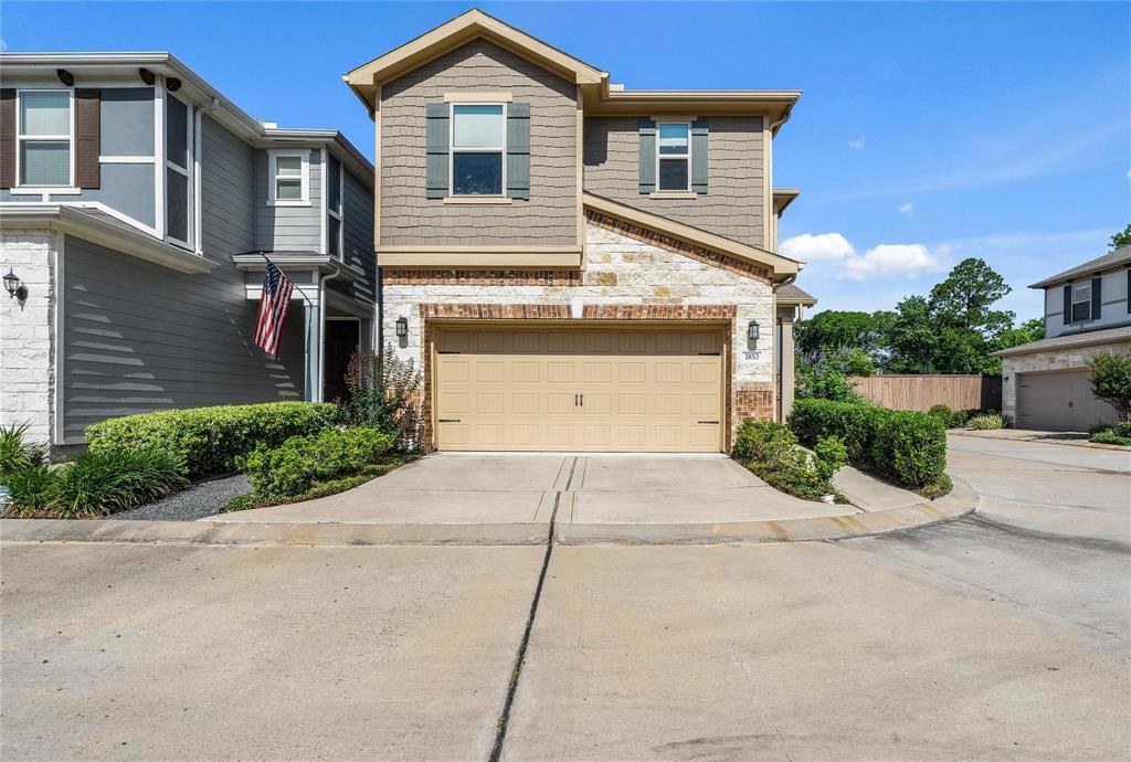 a front view of a house with a yard and a garage