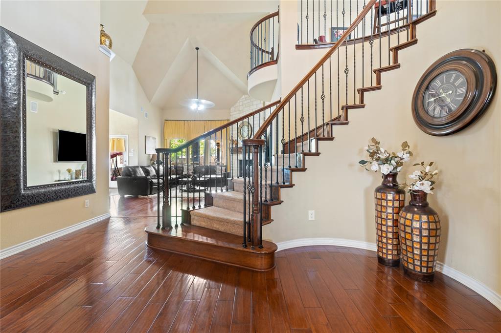 a view of entryway with wooden floor and a front door