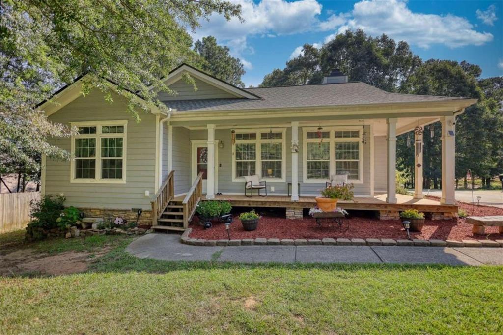 a front view of a house with a garden and patio