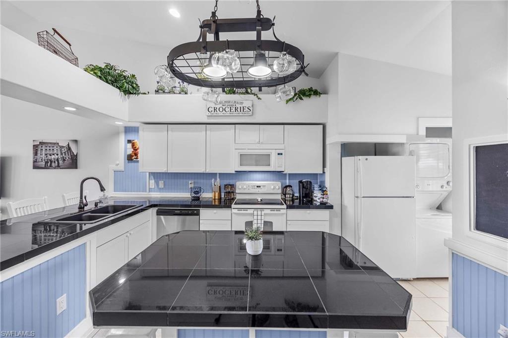 a kitchen with a sink a stove and cabinets