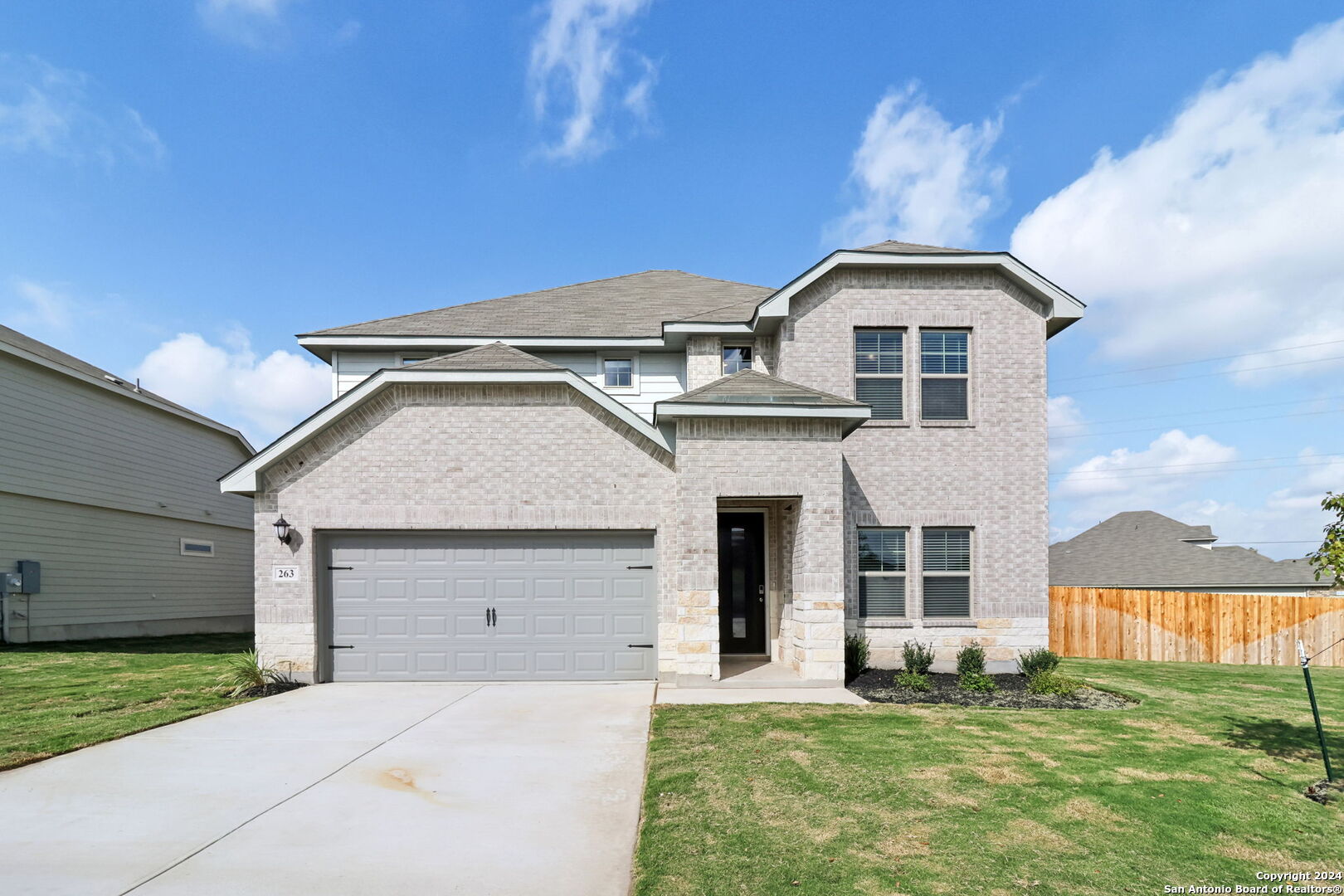 a front view of a house with a yard