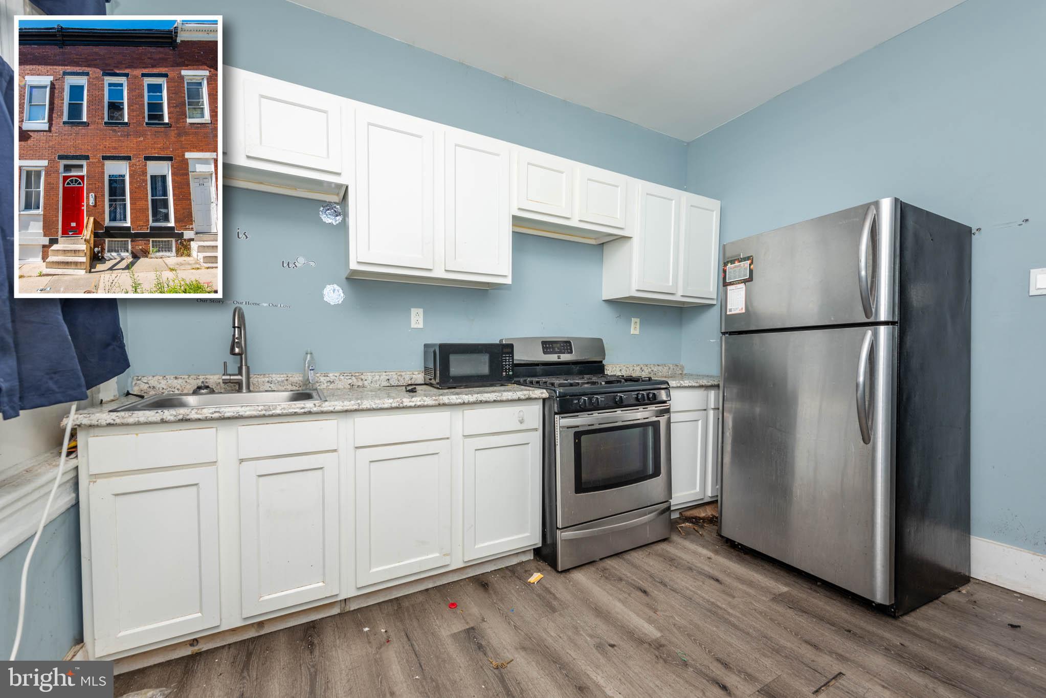 a kitchen with stainless steel appliances granite countertop a refrigerator sink and stove