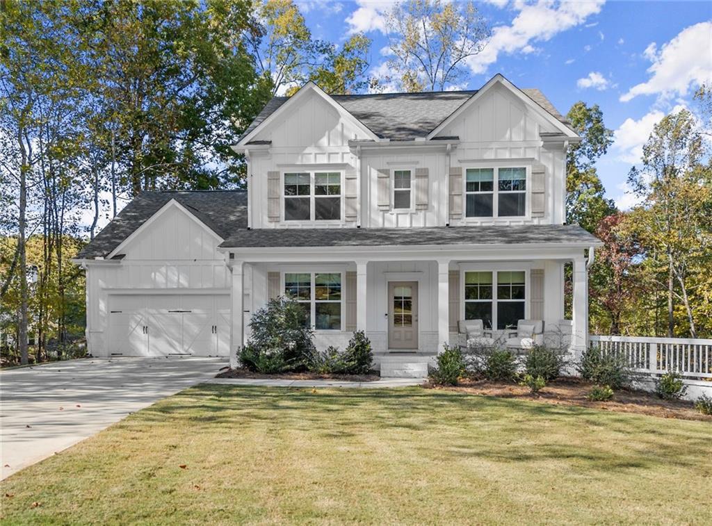 a front view of a house with a yard outdoor seating and garage