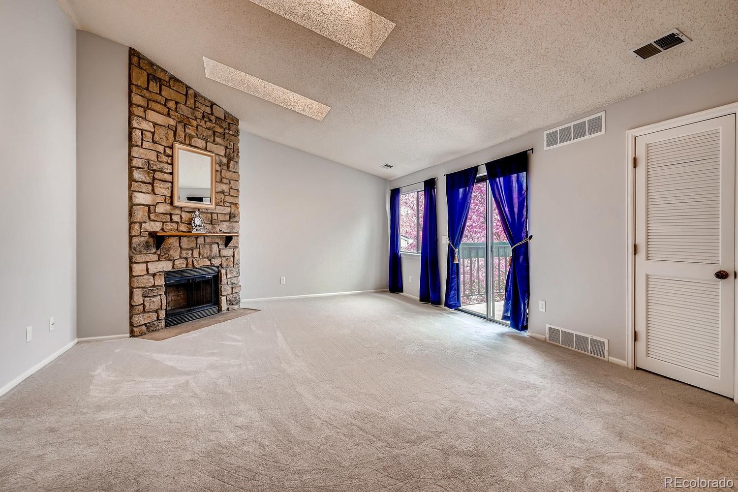 a view of a room with furniture and window